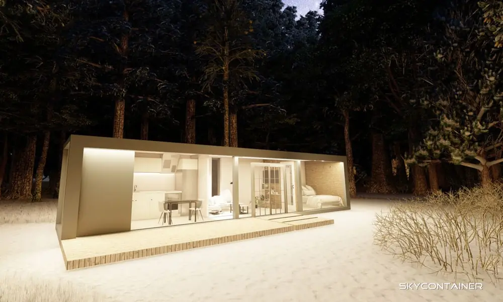 Narrow living container with brightly lit glazing among snow-covered trees