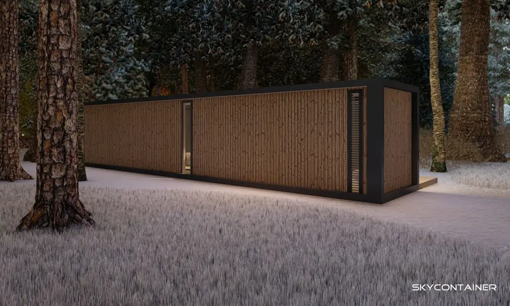 Closed timber facade of a small container home in a snowy forest