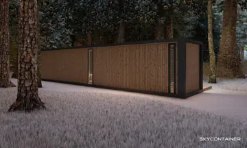 Geschlossene Holzfassade eines kleinen Containerhauses im verschneiten Wald