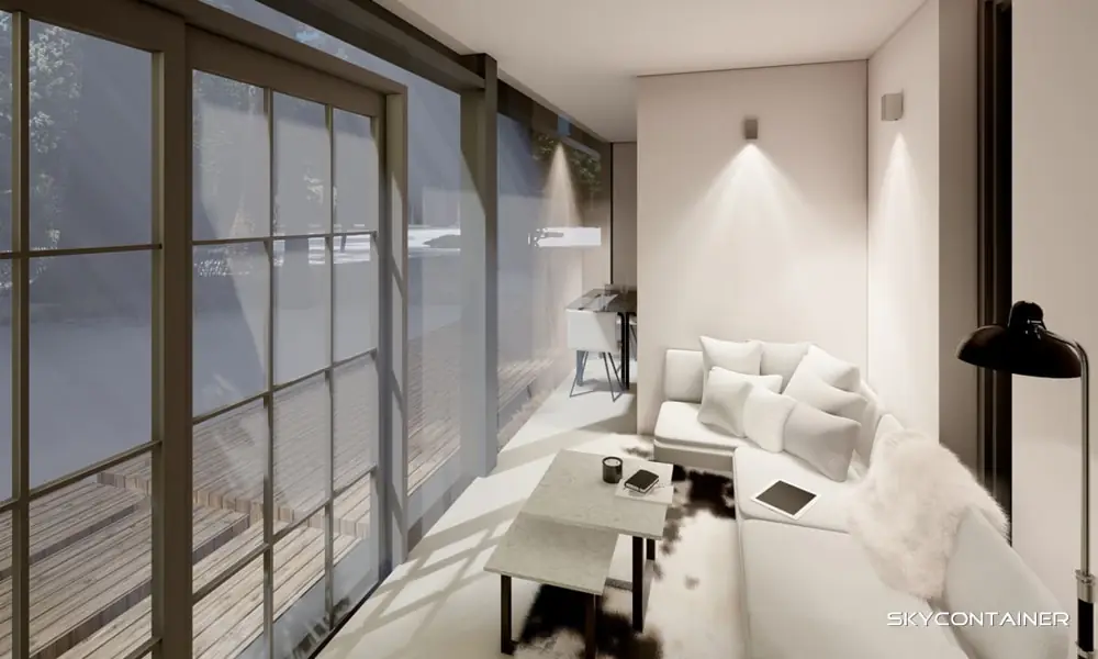 Bright tiny house living area with a sofa and dining table beside a glass wall