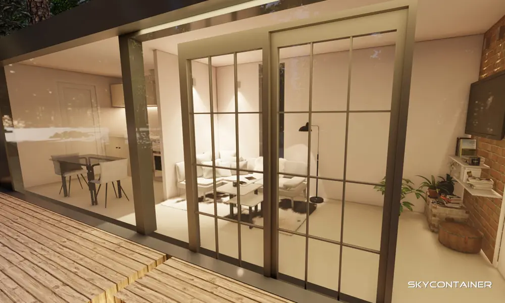 View from a timber terrace through glass doors towards a kitchen and seating area