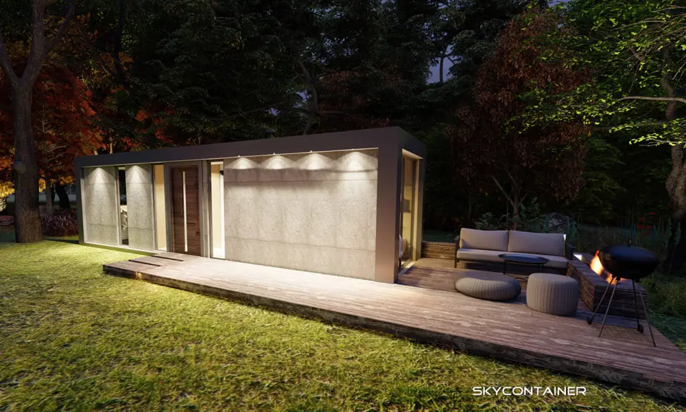 Side view of a garden living module with a terrace and seating group in autumn