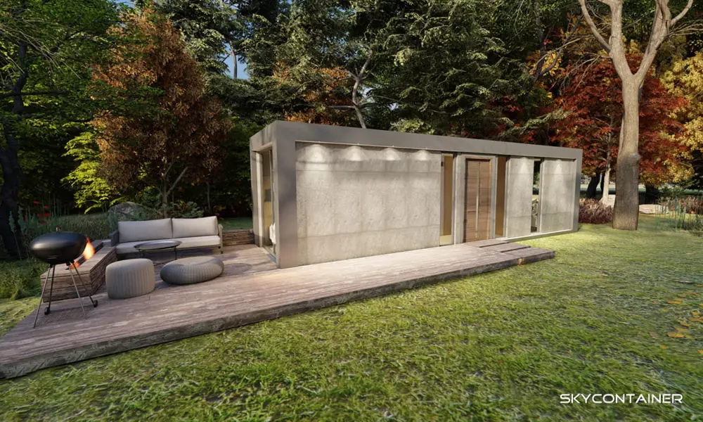 Garden bungalow with wide glazing and a timber terrace among autumn trees