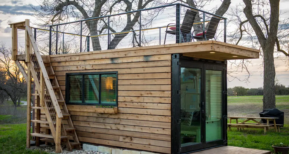 Small timber house with glazing among trees