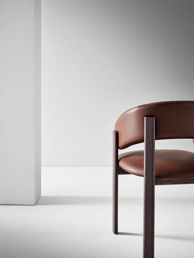 Bonaldo Alpha: Brown upholstered chair with a wrapping back and dark wooden frame · View 2