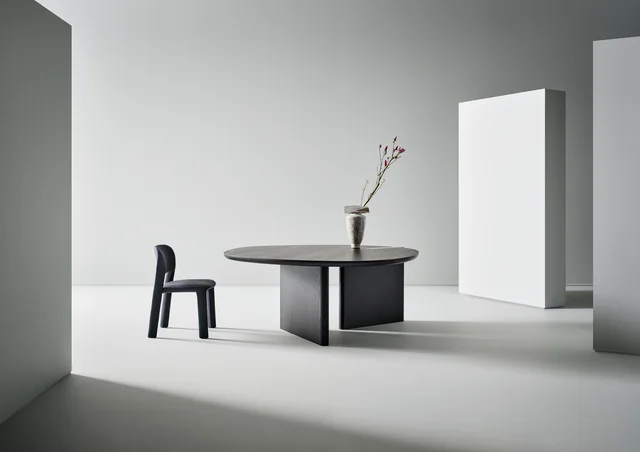 Bonaldo Flatiron table round top: Dark round table with asymmetrical planar supports · View 1