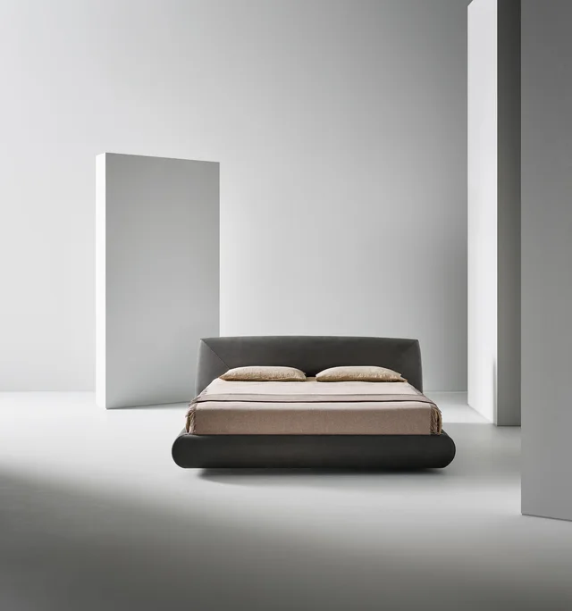 Bonaldo Holden: Dark upholstered bed with a low frame and angled headboard detail · View 2