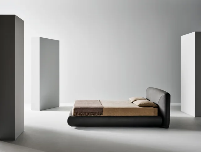 Bonaldo Holden: Dark upholstered bed with a low frame and angled headboard detail · View 3