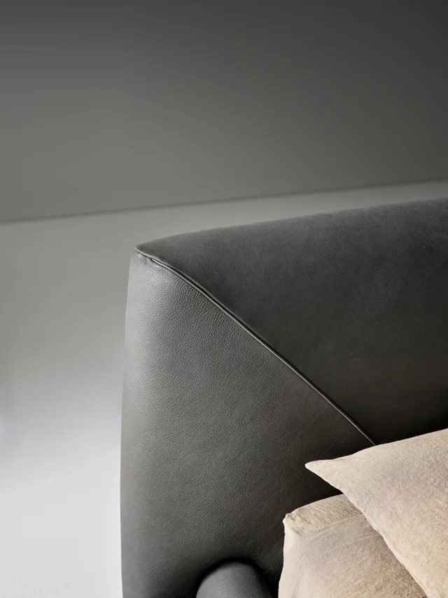 Bonaldo Holden: Dark upholstered bed with a low frame and angled headboard detail · View 4