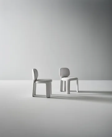 Bonaldo Teia: Pale upholstered chair with a rounded back and continuous rear legs · View 1