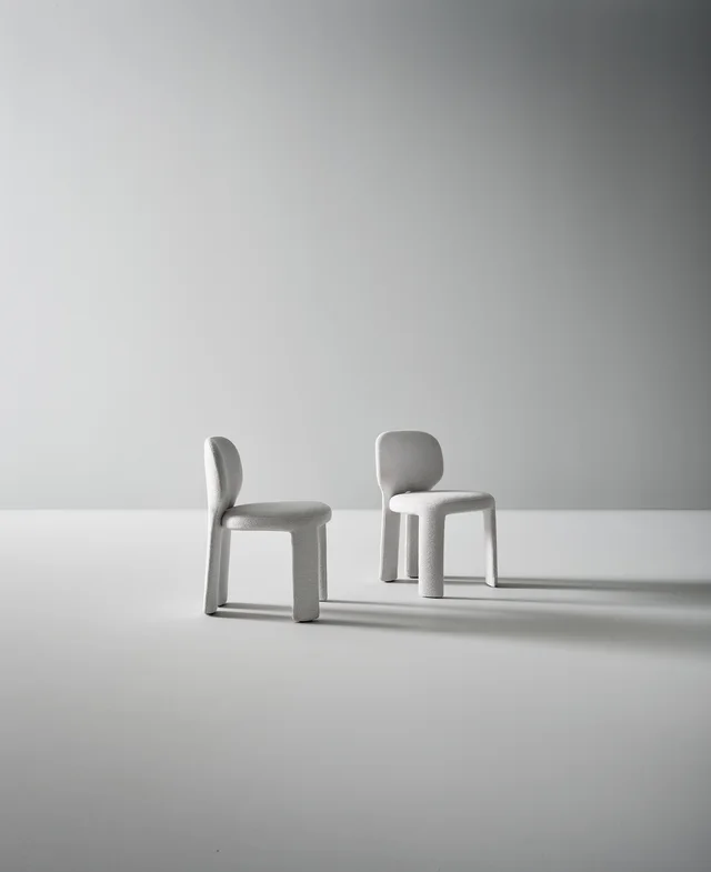 Bonaldo Teia: Pale upholstered chair with a rounded back and continuous rear legs · View 1