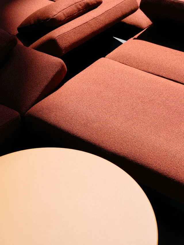 Fast Via Durini 2026: Street-side terrace with warm upholstery, plants and different table surfaces · View 10