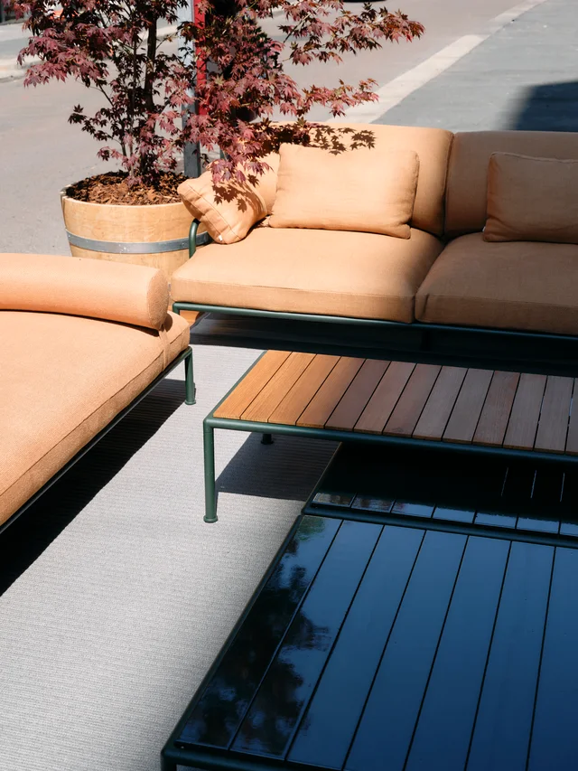 Fast Via Durini 2026: Street-side terrace with warm upholstery, plants and different table surfaces · View 11