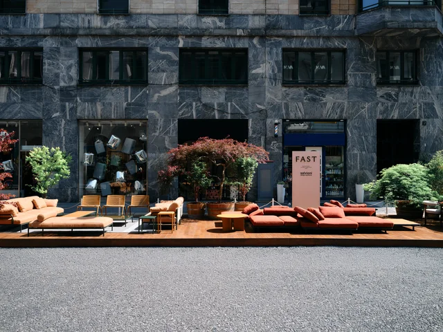 Fast Via Durini 2026: Street-side terrace with warm upholstery, plants and different table surfaces · View 15