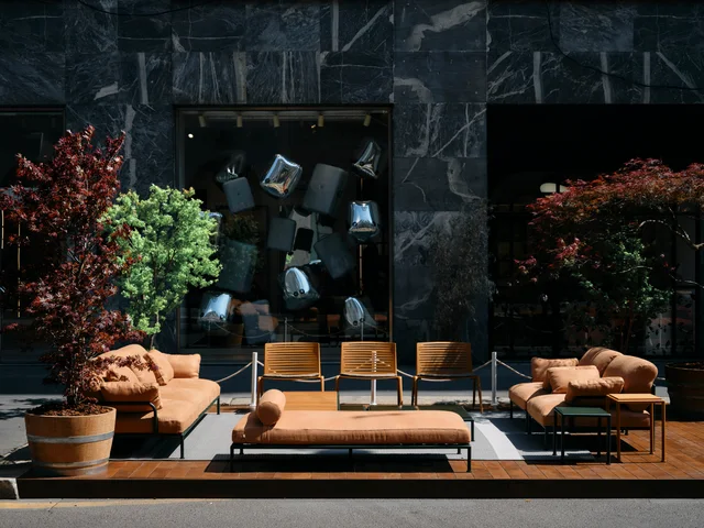 Fast Via Durini 2026: Street-side terrace with warm upholstery, plants and different table surfaces · View 16