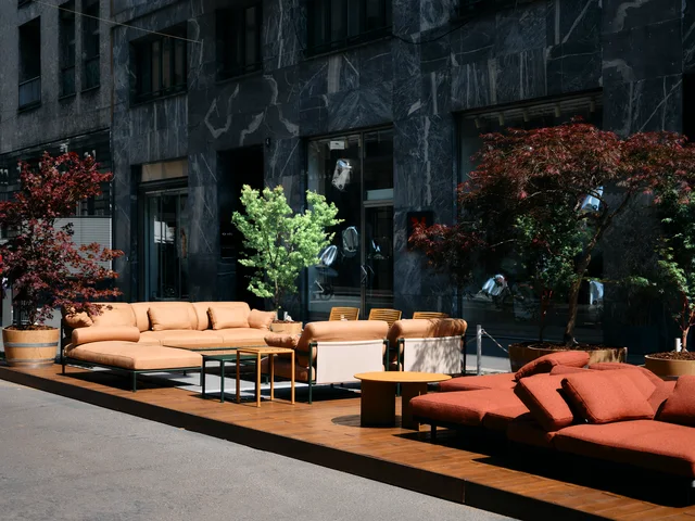 Fast Via Durini 2026: Street-side terrace with warm upholstery, plants and different table surfaces · View 18