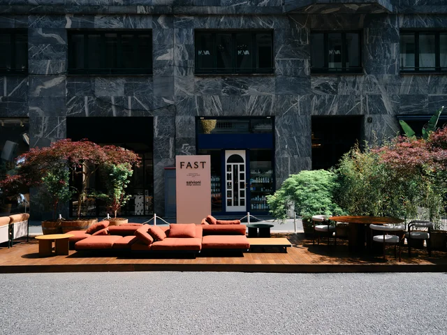 Fast Via Durini 2026: Street-side terrace with warm upholstery, plants and different table surfaces · View 19