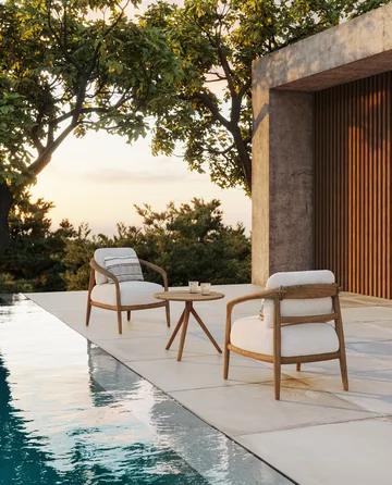 VONDOM FUSTA: timber armchairs with pale cushions beside a pool