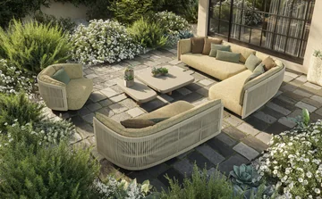 VONDOM SERRA: two pale sofas and a chair around a table on stone paving