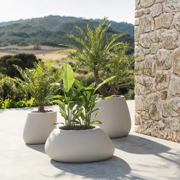 VONDOM STONE: different pale planters with green plants on a terrace